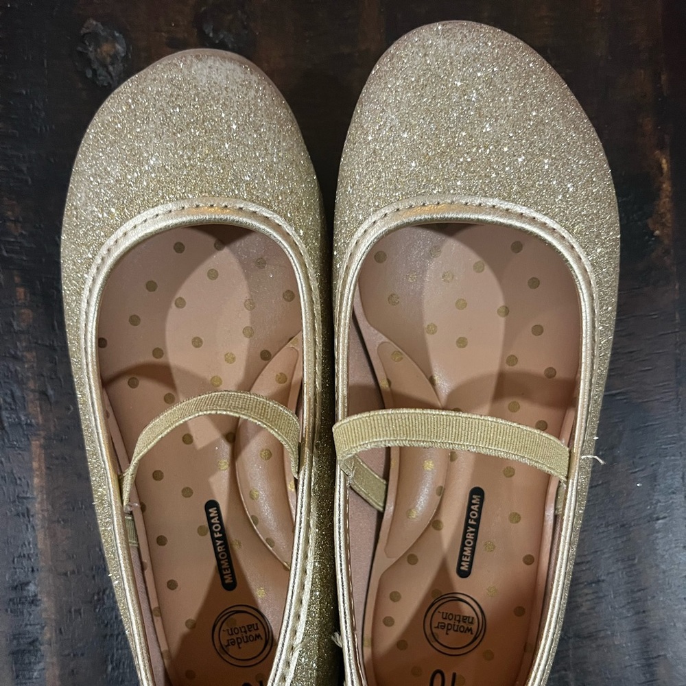 Sparkly gold flats with bows on back